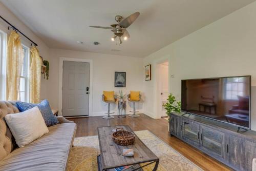 a living room with a couch and a flat screen tv at Bohemian Retreat Sleeps 6, two miles from Broadway! in Nashville