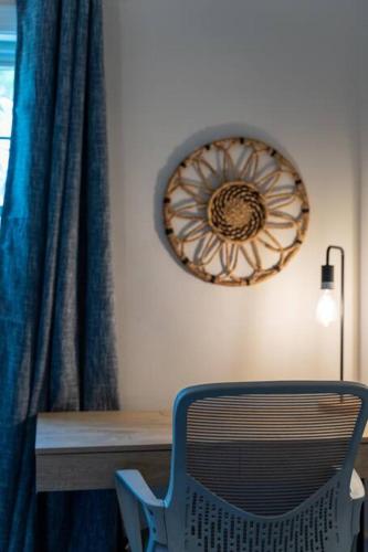 a blue chair sitting in front of a desk with a lamp at Bohemian Retreat Sleeps 6, two miles from Broadway! in Nashville
