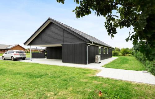 a black house with a garage at Pet Friendly Home In Sydals With Wifi in Neder Lysabild