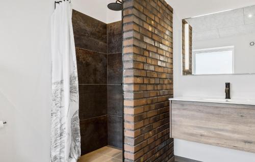 a bathroom with a shower and a brick wall at Pet Friendly Home In Sydals With Wifi in Neder Lysabild