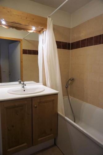 une salle de bain avec un lavabo, une baignoire et un miroir dans l'établissement Résidence Cristallines - 3 pièces 6 personnes MAE-7264, à Orcières