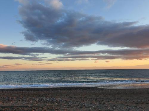 a beach with a cloudy sky and the ocean at La casa en el Mar in Almayate Alto