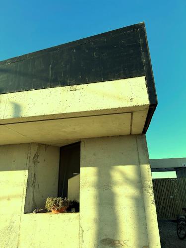 a building with a window with plants on it at CABITO B & B in La Paloma