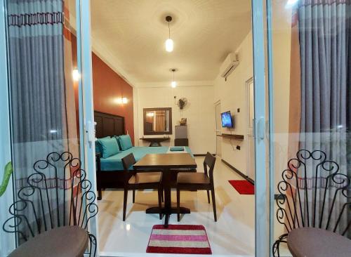 a dining room and living room with a table and chairs at CHEN VILLA - Near Airport in Negombo