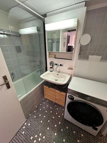a bathroom with a sink and a toilet and a shower at Appartement central avec Spa in Crans-Montana