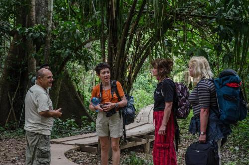 a group of people standing around in the forest at Monte Amazonico Lodge in Tambopata
