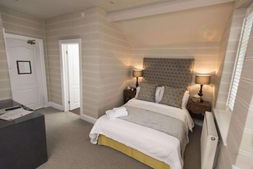 a bedroom with a bed and two night stands and two lamps at The Bear, Cowbridge in Cowbridge