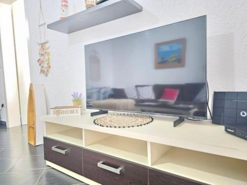 a living room with a large flat screen tv at Estia Seaview Apartment in Golem