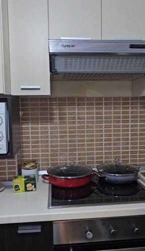 two pans sitting on top of a stove in a kitchen at Estia Seaview Apartment in Golem