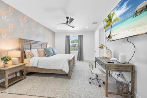 a bedroom with a bed and a desk at Delray Oasis - Private Pool - Fenced Yard - Parking - Laundry - Full Kitchen - Convenient Location in Delray Beach