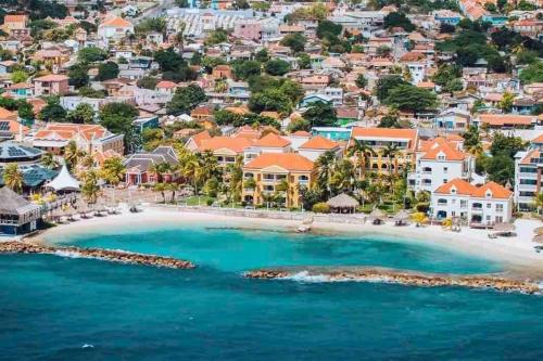an aerial view of a beach with houses at Cozy ocean view home - Jamella in Willemstad
