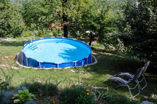 a swimming pool in the middle of a yard at Apartment Luno in Zvoneće