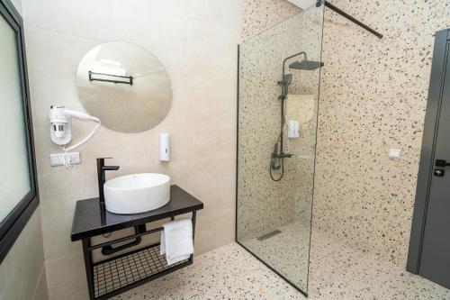 a bathroom with a sink and a shower at serenity stays-luxury suites & appart 2 in Tangier