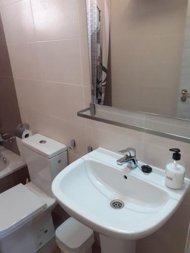 a bathroom with a white sink and a toilet at Like at Home in Costa de Antigua