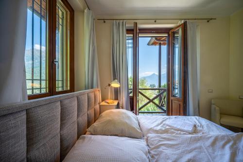 a bedroom with a bed and a window with a view at Ambra Ferienvilla in Menaggio