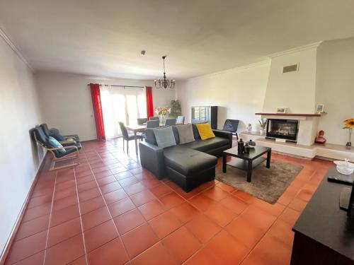 a living room with a couch and a table at Casa do Olival in Peso da Régua