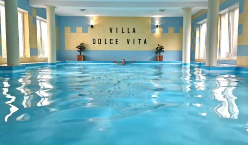 a person swimming in a swimming pool at Villa Dolce Vita in Łeba