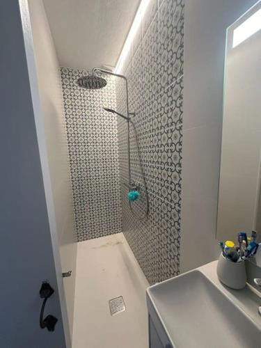 a shower in a bathroom with a sink at Casita Estrella in Arenal d'en Castell