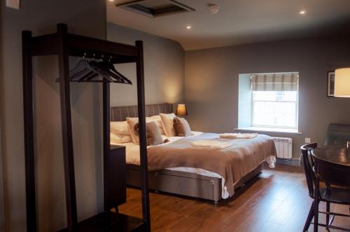 a bedroom with a large bed and a mirror at Seven Stars Penryn in Penryn