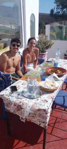 a man and a woman sitting at a table at Dar janoub in Aït Raïs Aomar
