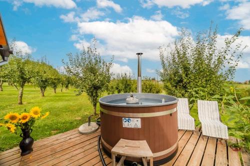 a hot tub sitting on top of a wooden deck at Eco House Lina With Hot Tub and Sauna - Happy Rentals in Lopatinec
