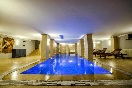 a swimming pool with blue water in a building at Boğaz Manzaralı Havuzlu Lüks Villa in Istanbul