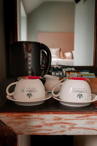 two cups and saucers sitting on a table at Seven Stars Penryn in Penryn