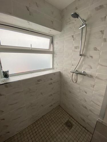 a bathroom with a shower and a window at Hayfield View in Gaddagh Bridge