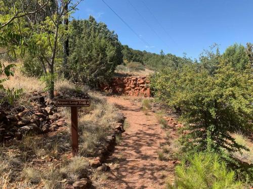 a trail sign on the side of a dirt road at Writer's Room SaddleRock Ranch B&B West Sedona in Sedona