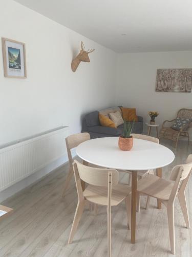 a white table and chairs in a living room at Hayfield View in Gaddagh Bridge
