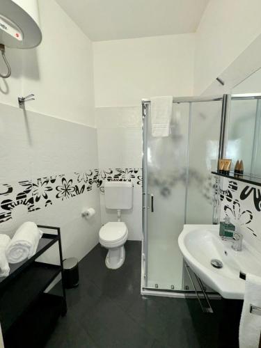 a bathroom with a shower and a toilet and a sink at La Magione in Palermo