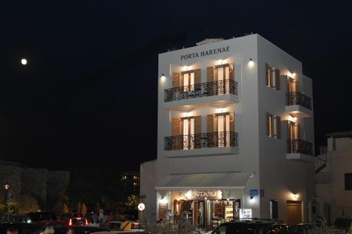 a large white building with lights on it at night at Porta Harenae Residencia in Chania