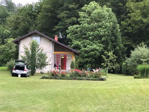 a small house with a car parked in front of it at Palučak 30 in Babice Gornje