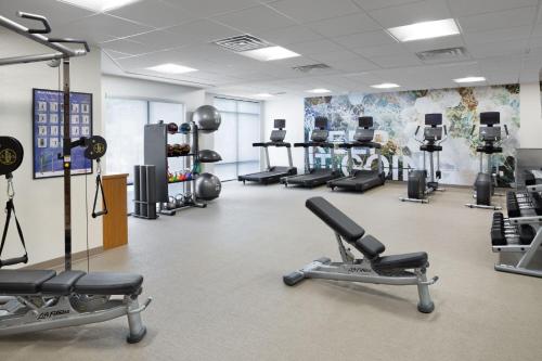 a gym with several treadmills and exercise machines at SpringHill Suites Milford in Milford