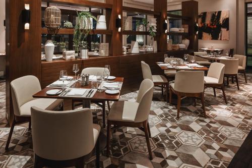 a restaurant with tables and chairs in a room at The Santa Maria, a Luxury Collection Hotel & Golf Resort, Panama City in Panama City