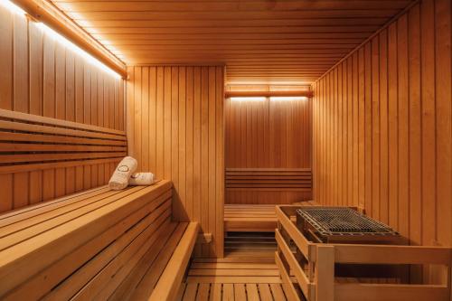 a sauna with wooden walls and wooden flooring and a wooden bench at The Santa Maria, a Luxury Collection Hotel & Golf Resort, Panama City in Panama City