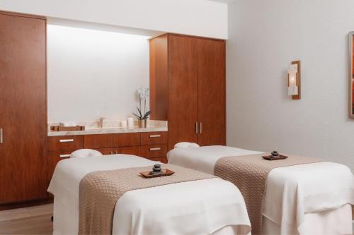 a room with three beds with white table cloth at The Santa Maria, a Luxury Collection Hotel & Golf Resort, Panama City in Panama City