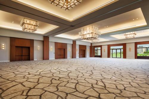 an empty room with a large ballroom with chandeliers at The Santa Maria, a Luxury Collection Hotel & Golf Resort, Panama City in Panama City
