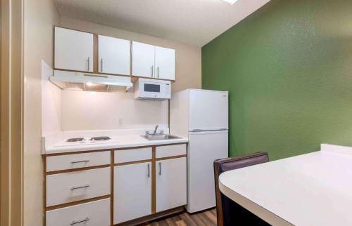a kitchen with a white refrigerator and a sink at Extended Stay America Select Suites - Atlanta - Perimeter - Hammond Drive in Atlanta