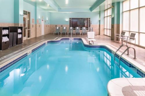 a large pool with blue water in a hotel room at SpringHill Suites by Marriott Pittsburgh North Shore in Pittsburgh