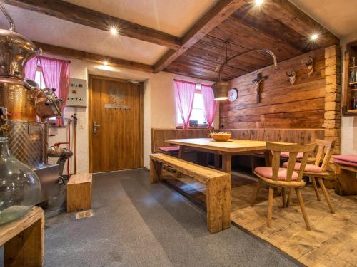 a dining room with a wooden table and a bench at Blick zum Mayrhofen in Ramsau im Zillertal