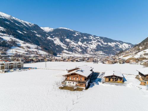 a village in the snow with mountains in the background at Blick zum Mayrhofen in Ramsau im Zillertal