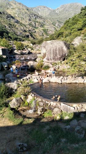 a group of people in a pool of water at Serra da Estrela - Casa Castro in Gouveia
