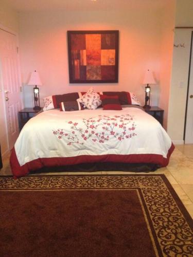 a bedroom with a large bed with red pillows at Garden Oasis at Banana Hale Studio in Kawailiula