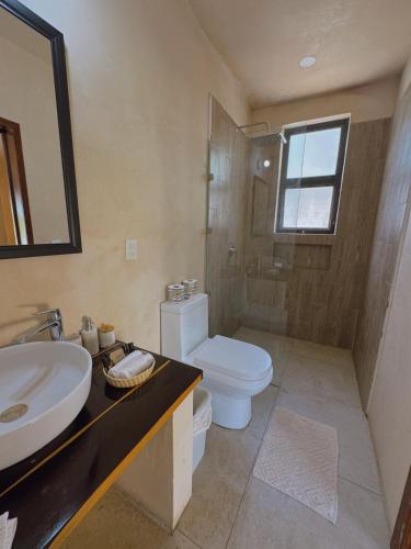 a bathroom with a sink and a toilet at Villas Mandarina Bacalar in Bacalar