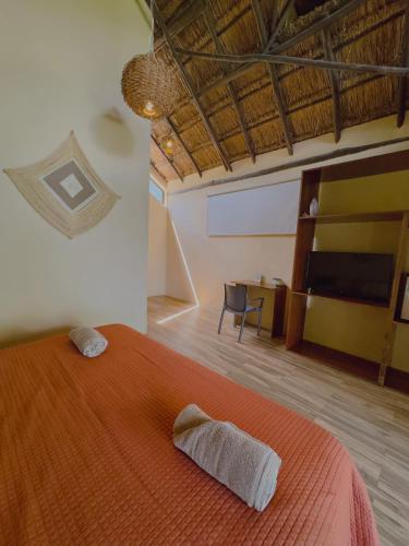 a bedroom with a bed with two towels on it at Villas Mandarina Bacalar in Bacalar