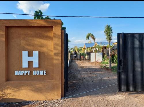 a happy home sign on the side of a building at Happy home in Huu