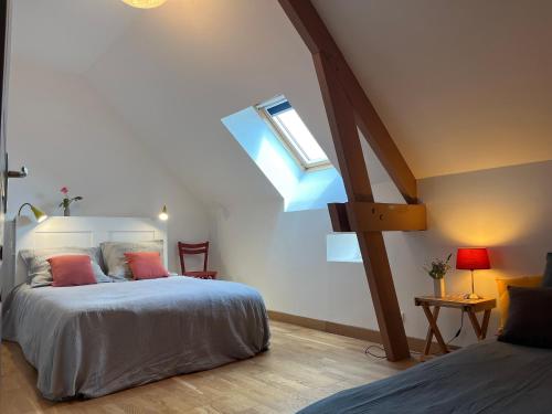 a bedroom with a bed and a skylight at Maison typique en Berry avec jardin privatif, BBQ et parking - FR-1-591-598 in Thenay