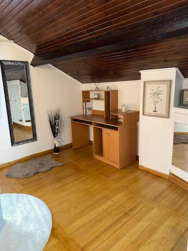 Cette chambre dispose d'une cuisine avec une table et un miroir. dans l'établissement Maison Perle rare 2 