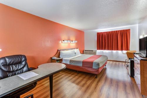 a small hotel room with a bed and a chair at Motel 6-Portland, OR - Tigard West in Tigard
